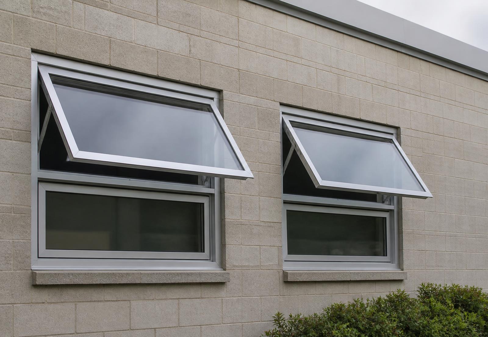 Aluminum awning windows projected open in a masonry wall